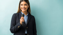 Pretty Businesswoman Giving Speech In Studio